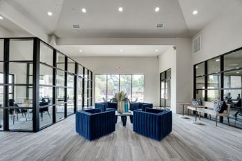 Clubhouse lobby with blue seating and black framed glass walls